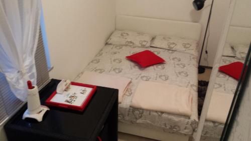 a small room with a small bed with a red box at Studio Apartment Kala in Split