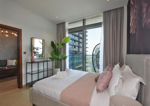 a bedroom with a bed and a large window at Marina Gate Modern & Unique 1 Bed by AirDHP in Dubai