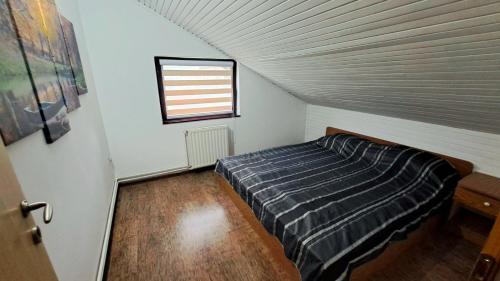 a bedroom with a bed in a attic at Bosnian Villa in Hadžići