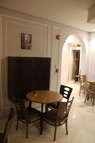 a dining room with a table and chairs at Miramar Downtown in Cairo