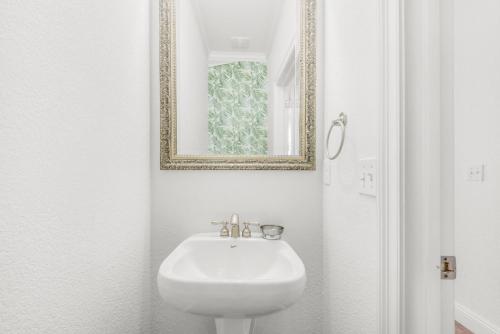a bathroom with a white sink and a mirror at Bliss Getaway in Destin