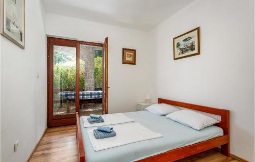 a white bedroom with a bed and a window at 2 Bedroom Lovely Apartment In Pinezici in Pinezici