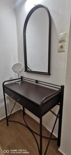 a dressing table with a mirror on a wall at Η Αρμενόπετρα in Gerolimenas