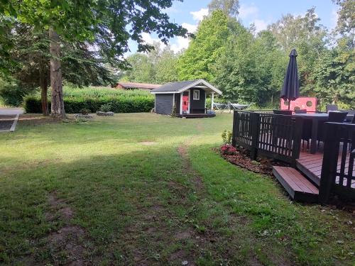 a backyard with a gazebo and a fence at Holiday house, one hour away from Copenhagen, pets allowed, 4 rooms in Jægerspris