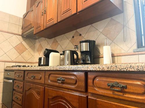 a kitchen with a counter top with a coffee maker at AL Ribeirinho in Mértola