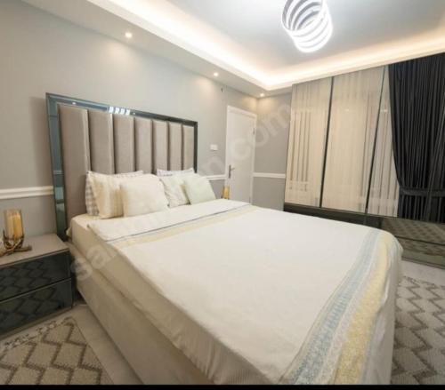 a bedroom with a large white bed in a room at MAX 3+1 in Istanbul