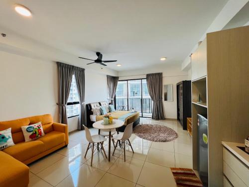 a living room with a couch and a table with chairs at Studio I-Soho D'Gunduls Homestay by DGH I-CITY in Shah Alam