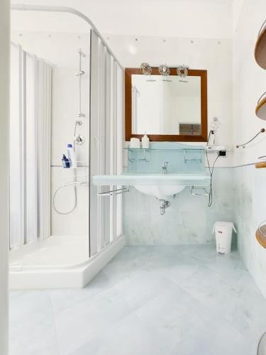 a bathroom with a sink and a mirror at Gravina suite Apartment in Gravina in Puglia