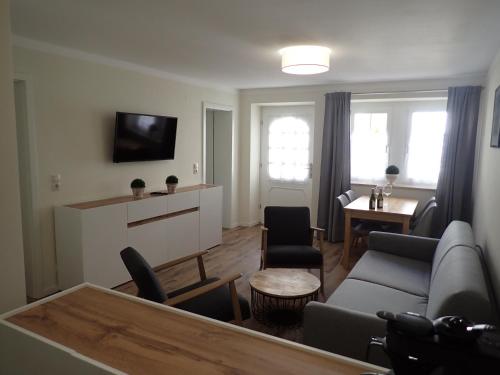 a living room with a couch and a table at Karlbacher Domizil Ferienwohnungen in Großkarlbach