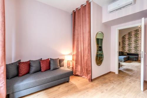 a living room with a couch and a mirror at DOWNTOWN SRL - Croce di Malta Royale in La Spezia
