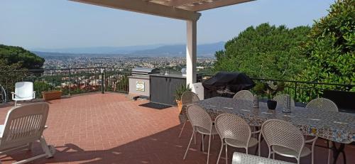 a table and chairs on a patio with a view at La Terrazza Quisisana Sorrento Coast in Castellammare di Stabia