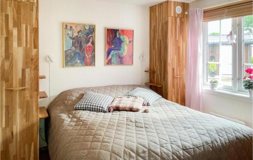 a bedroom with a bed with two pillows on it at Nice Home In Halmstad With Kitchen in Öppinge