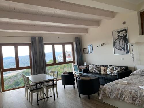 a bedroom with a bed and a table and chairs at Appartamenti Raggio di Sole in Castel del Monte