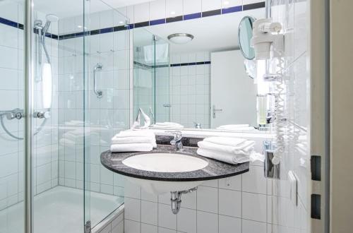a bathroom with a sink and a shower at Villa Kurpark in Zingst