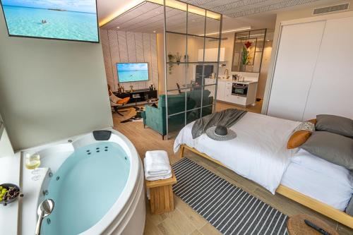 a bathroom with a bed and a bath tub at Mina's luxury suite - panoramic sea view- קיסריה in Caesarea