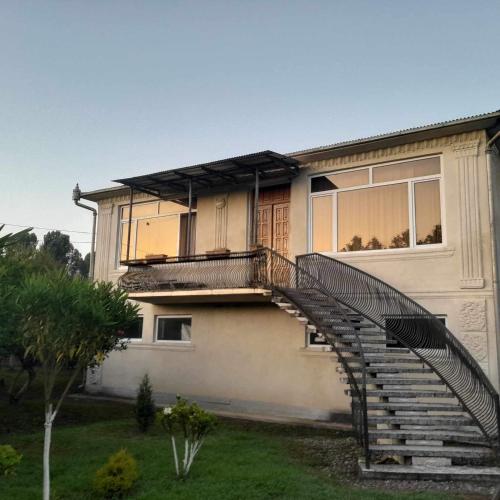 a house with a staircase in front of it at Ani's Green House in Anaklia