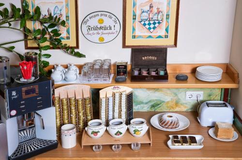 a shelf with cups and other items on it at Self-Check-in Hotel VinoQ Mistelbach in Mistelbach