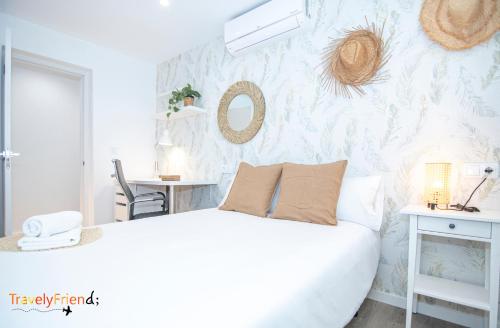 a bedroom with a white bed and a wall at APARTAMENTO COMPLETO SAN FRANCISCO in Santiago de Compostela