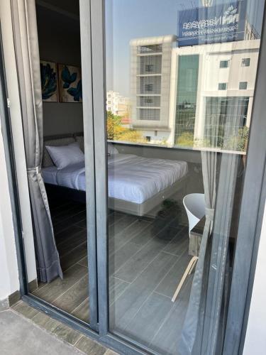 a view of a balcony with a bed and a window at Mod Avenue in Gurgaon