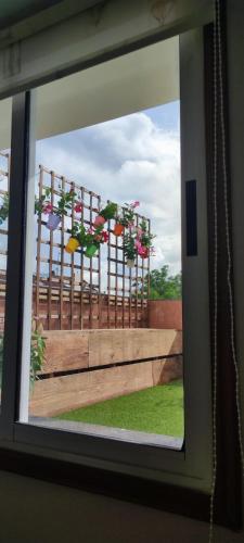 a window with a bunch of flowers on a fence at Pensión Lobre in O Pedrouzo