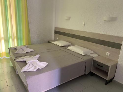 a bed with towels on it in a room at Georgina in Agia Marina Aegina