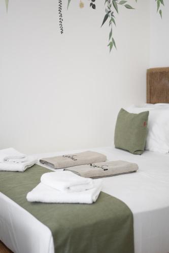 a bedroom with two beds with towels on them at Sabbia Mini Pool Suites in Preveza