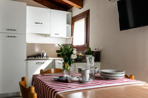 a dining room table with a red and white striped table cloth at La Conchiglia in Chioggia