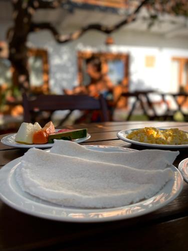 a table with plates of food on top of it at Oka Pousada Atins in Atins