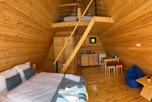 a bedroom with a bed in a wooden cabin at Cozy Cottages in Mestia