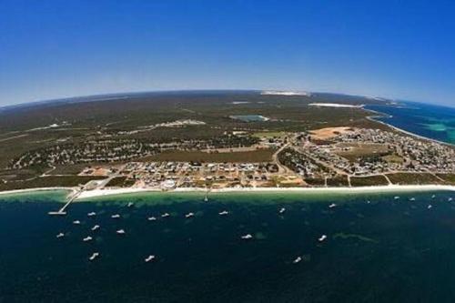 an aerial view of a small island in the ocean at dhu drop inn in Cervantes