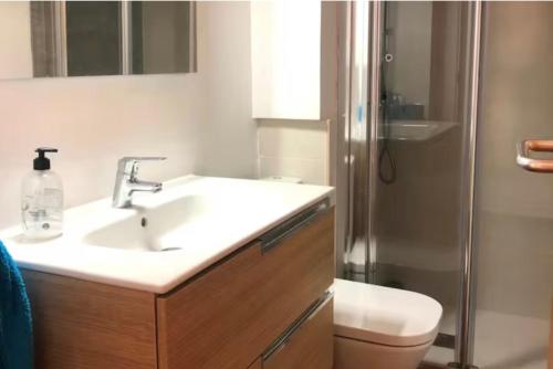 a bathroom with a sink and a toilet and a shower at Pals Playa 1era linea de mar, villa de golf in Begur