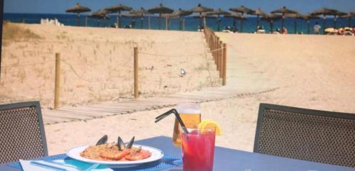 a table with a plate of food on the beach at Pals Playa 1era linea de mar, villa de golf in Begur