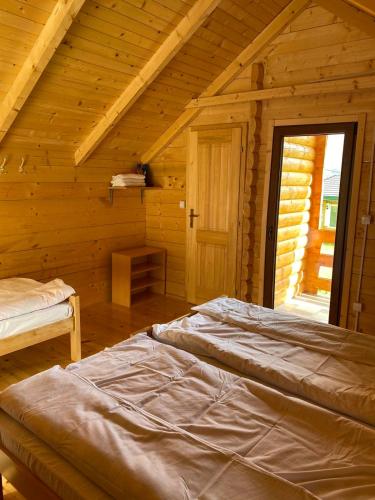 a bedroom with a bed in a wooden cabin at Gusinje View in Gusinje