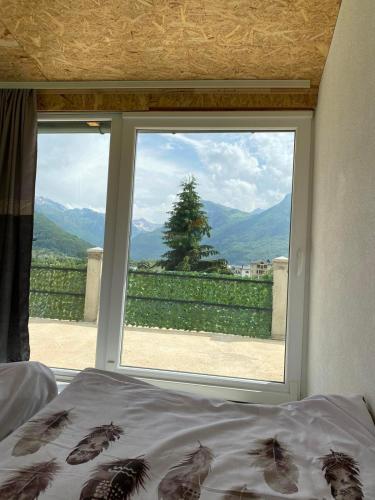 a bedroom window with a view of a mountain view at Gusinje View in Gusinje