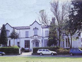 a white car parked in front of a white house at Victoria Park Hotel in Manchester