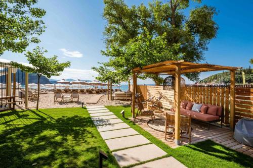 a backyard with a couch under a gazebo at Eterrano Seaside Retreat in Parga