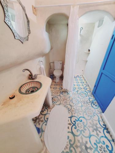 a bathroom with a sink and a toilet at Riad AYLAL in Essaouira