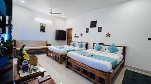 a room with two beds in a room at THE LUXE HOTEL in Puducherry