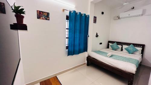 a small bedroom with a bed and a window at THE LUXE HOTEL, ECR ROAD, NEAR Serenity Beach, Pondicherry - JR Groups in Puducherry