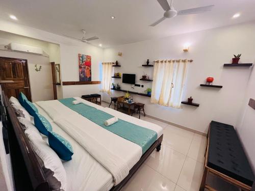 a bedroom with a large bed and a table at THE LUXE HOTEL, ECR ROAD, NEAR Serenity Beach, Pondicherry - JR Groups in Puducherry