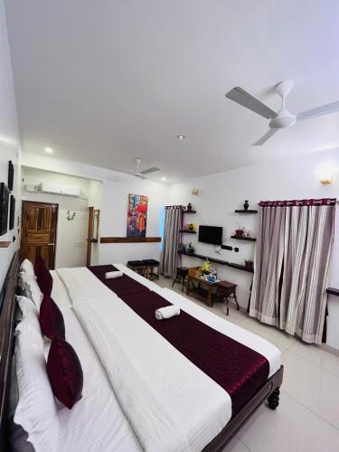 a bedroom with a large bed in a room at THE LUXE HOTEL, ECR ROAD, NEAR Serenity Beach, Pondicherry - JR Groups in Puducherry