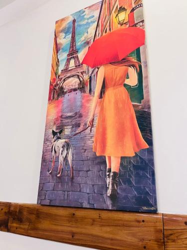 a painting of a woman with an umbrella and a dog at THE LUXE HOTEL, ECR ROAD, NEAR Serenity Beach, Pondicherry - JR Groups in Puducherry