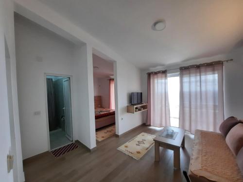 een woonkamer met een bank en een raam bij Studio Apartments Jupo in Ulcinj