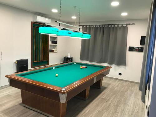 a pool table in a room with a ping pong ball at Villafiorita in Gioiosa Marea