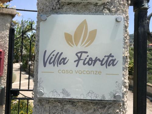 a sign for the villa fiumicino in a resort at Villafiorita in Gioiosa Marea