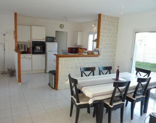 een keuken en eetkamer met een tafel en stoelen bij HOUSE CLOSE TO ROYAN AND SEASIDE, GROUND FLOOR, QUIET AND COMFORTABLE in Médis