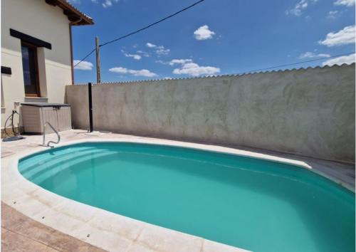 a swimming pool in front of a fence at Casa Rural Villa Cárcavas in Maello