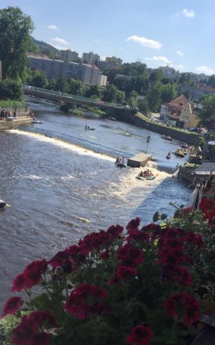 a river with boats and people swimming in it at Pension Plešivecká 119 in Český Krumlov