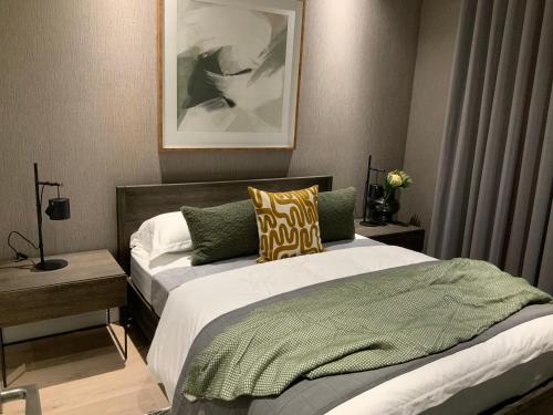 a bedroom with two beds and a picture on the wall at 5 Star Elegant Apartments, Ellipse Waterfall City, Midrand, Johannesburg in Midrand