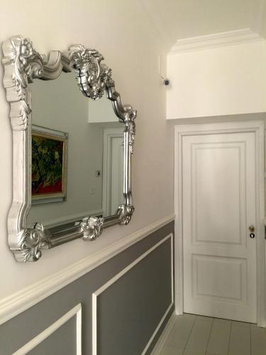a mirror on a wall in a room at TAM Vacanze B&B in Cinisi